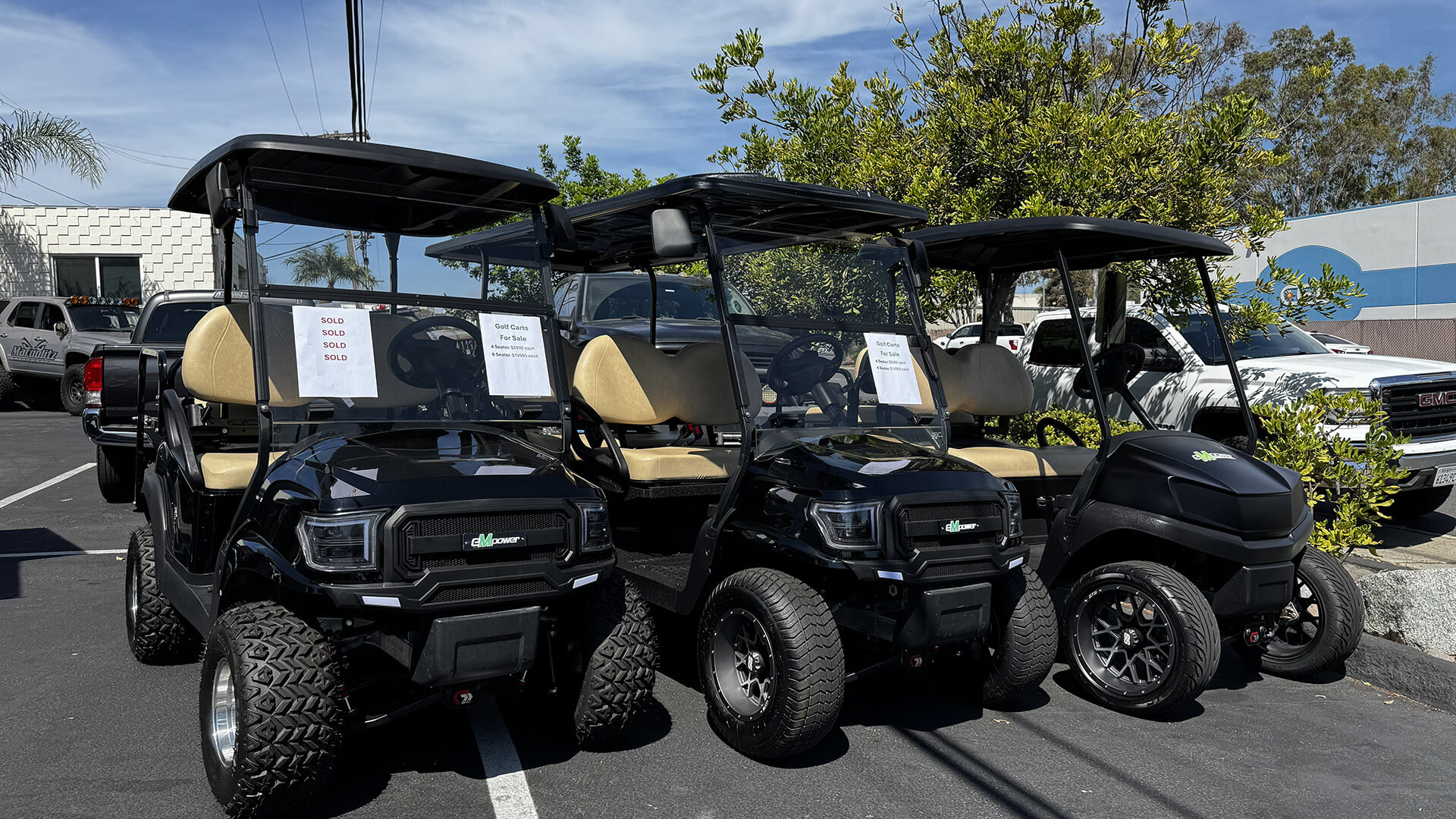 Row of black eMpower street legal carts, front one marked sold